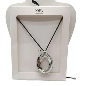 Zara Long Necklace With Silver Tone Oval Pendant and Black Cord